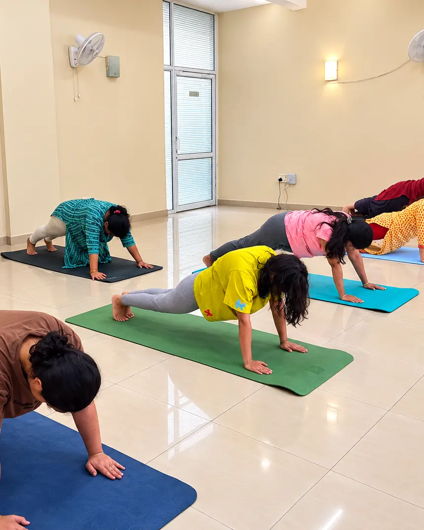 A morning yoga class moving through Surya Namaskar at the Living Yog studio in Palam Vihar, Gurugram