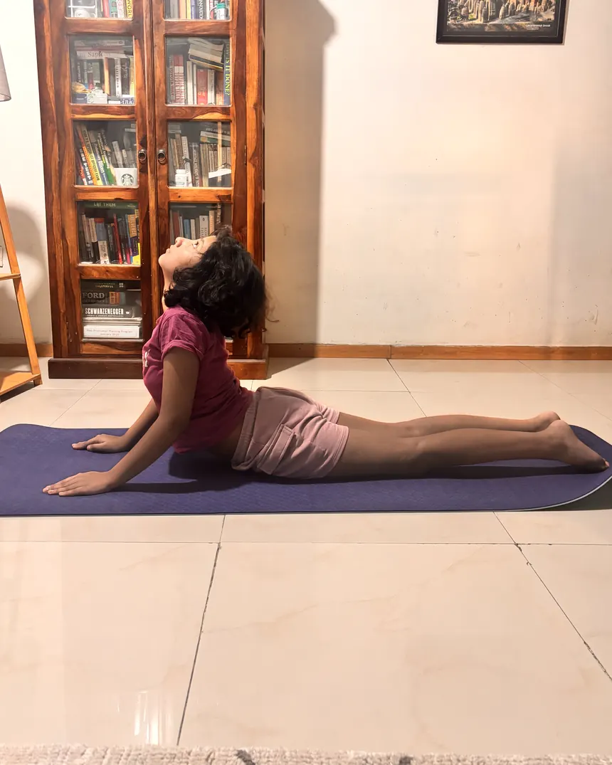 A student in bhujangasana during a Living Yog class
